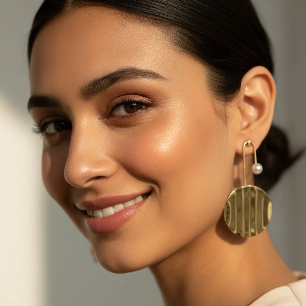 Aven gold pearl drop earrings styled on model