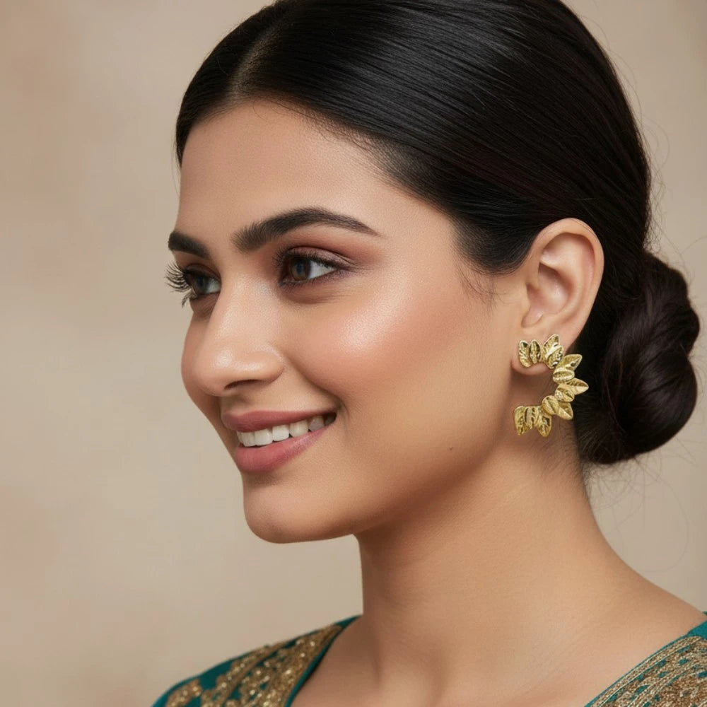 Model wearing Ivy Curve gold leaf earrings